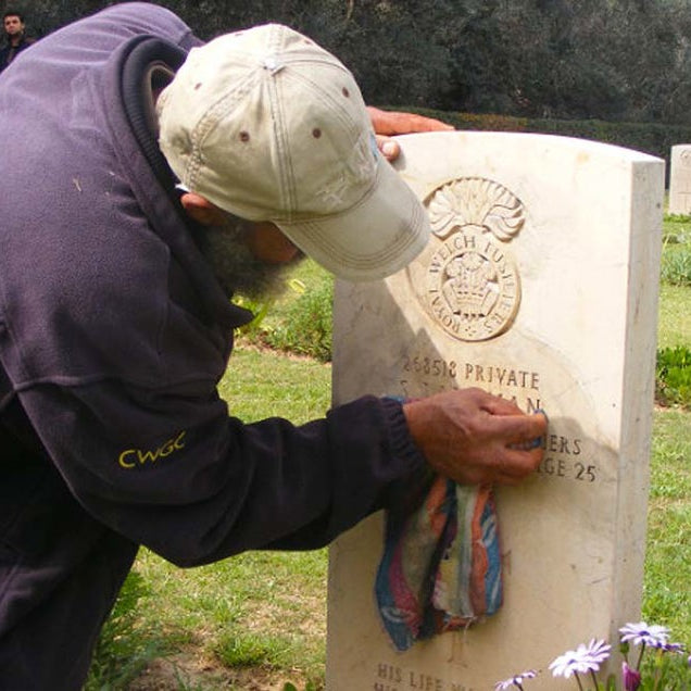 Man cleaning headstone